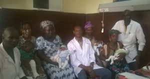 Agbo-Panzo (center) poses with colleagues, patients and family members at his hospital in Conakry, Guinea.