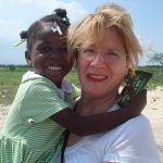 Sobus enjoys a visit with Metinise, a Haitian girl she sponsors through a local charity