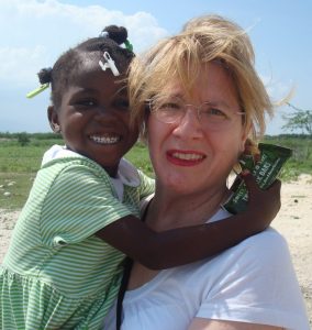 Sobus enjoys a visit with Metinise, a Haitian girl she sponsors through a local charity.